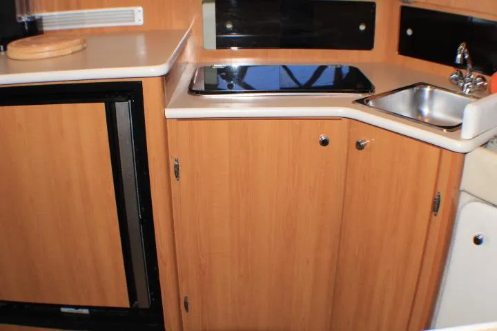 Slide: The Image of Interior of 2002 Bayliner 3055 Ciera with curved seating and table. - 42