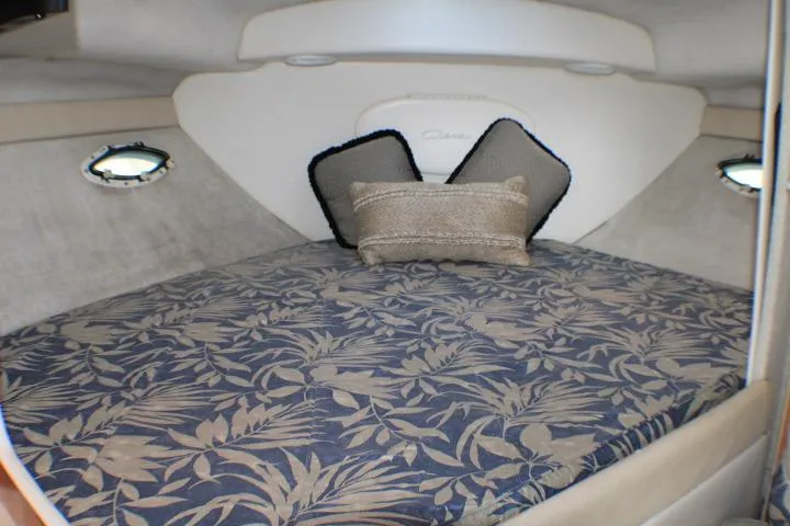 Slide: The Image of 2002 Bayliner 3055 Ciera boat kitchen with wood cabinets, sink, and stovetop. - 44