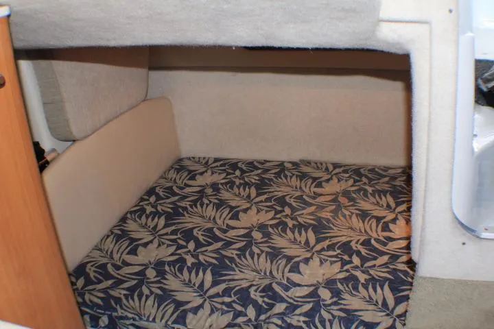 Slide: The Image of Interior cabin of 2002 Bayliner 3055 Ciera with floral bedding and porthole window. - 47