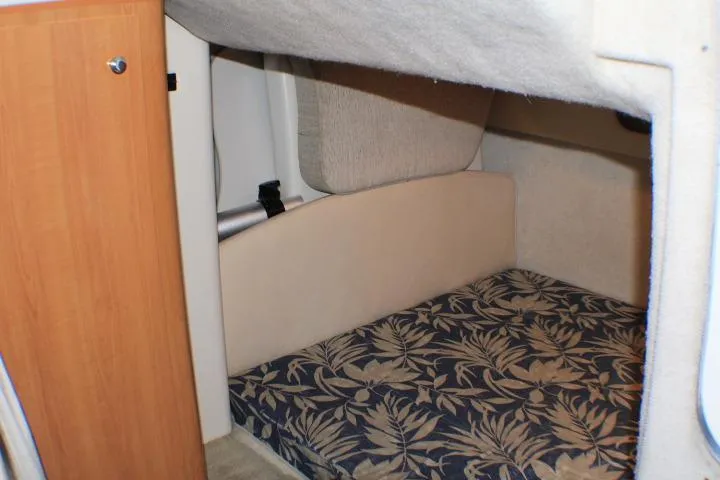 Slide: The Image of Interior cabin of 2002 Bayliner 3055 Ciera with floral upholstery and small window. - 48