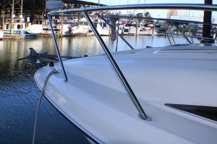 Slide: The Image of 2002 Bayliner 3055 Ciera boat under a metal roof, showcasing cockpit and canopy. - 6