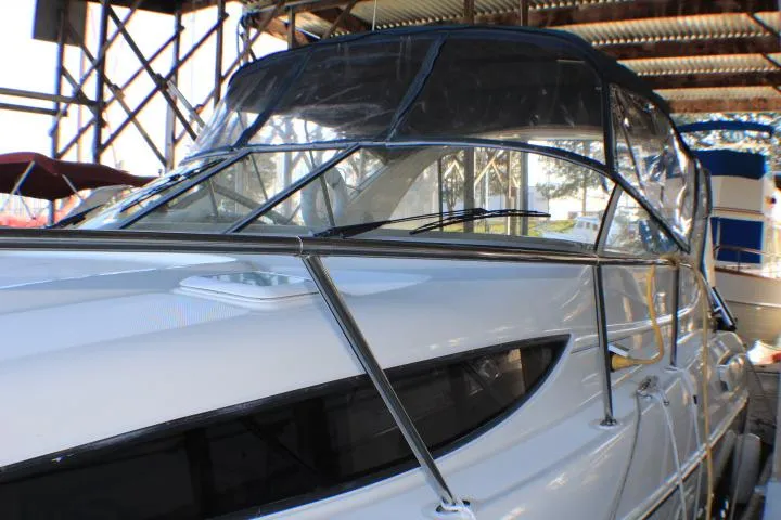 Slide: The Image of 2002 Bayliner 3055 Ciera docked at a marina, showcasing sleek bow design. - 7