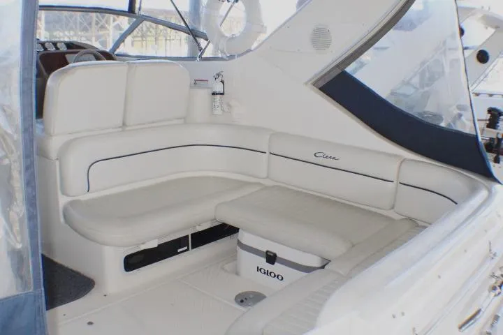 Slide: The Image of 2002 Bayliner 3055 Ciera boat with covered cockpit in a marina setting. - 8