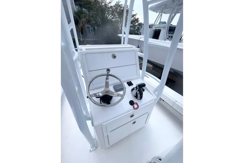 Slide: The Image of 2021 Dorado Flatdeck boat console with steering wheel and controls. - 8
