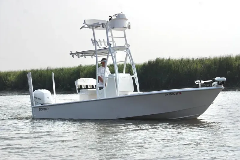 Slide: The Image of 2021 Dorado Flatdeck boat on water, featuring elevated tower and outboard motor. - 1