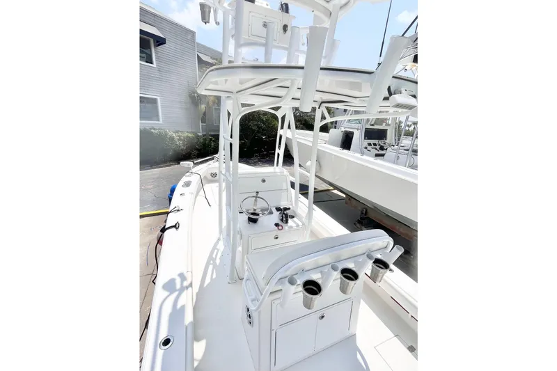 Slide: The Image of 2021 Dorado Flatdeck boat interior with steering console and rod holders. - 10
