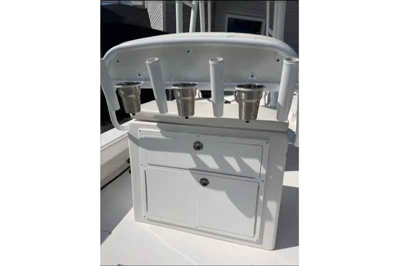 Slide: The Image of 2021 Dorado Flatdeck boat console with rod holders and storage compartments. - 11