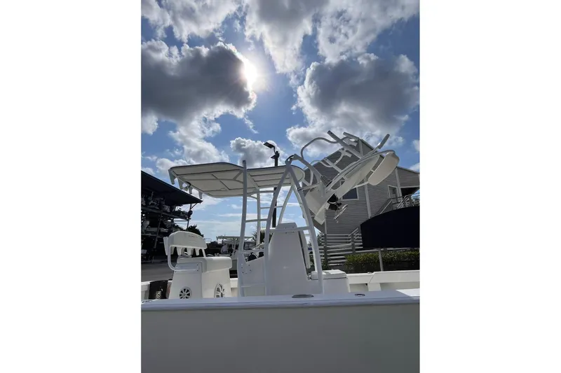 Slide: The Image of 2021 Dorado Flatdeck boat under cloudy sky with sun peeking through. - 3