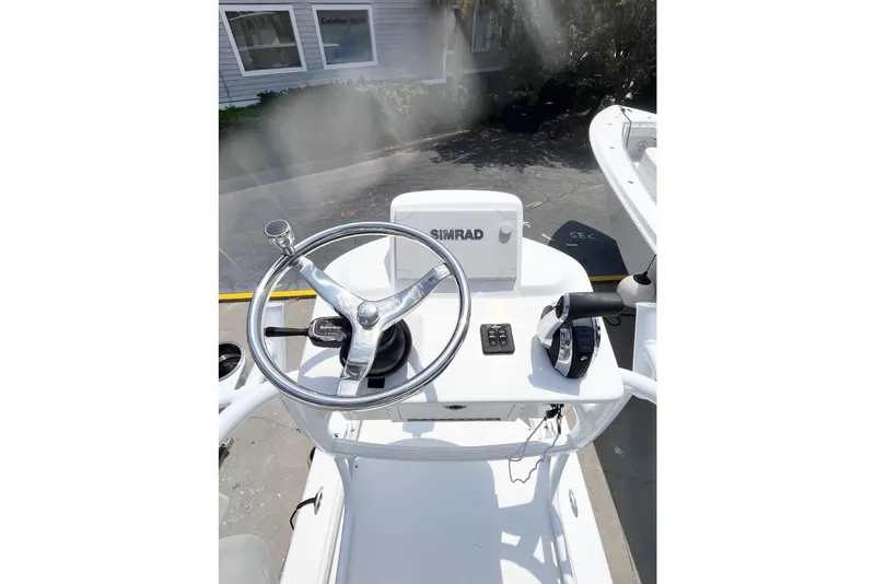 Slide: The Image of 2021 Dorado Flatdeck boat helm with steering wheel and Simrad navigation system. - 5