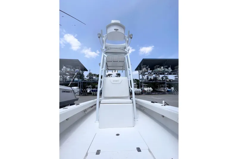 Slide: The Image of 2021 Dorado Flatdeck boat with tower, docked under clear blue sky. - 6