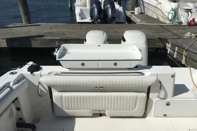 Slide: The Image of 2004 Wellcraft 290 Coastal boat with dual engines docked at a marina. - 4