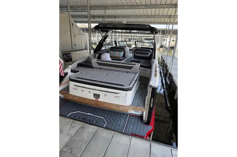 Slide: The Image of 2025 Cobalt R35 boat docked, featuring spacious seating and modern design. - 13