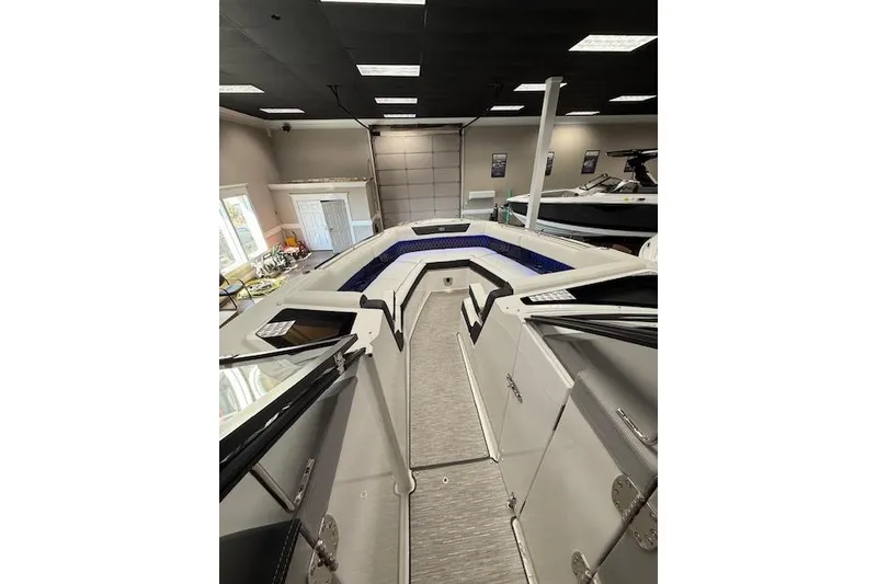 Slide: The Image of 2025 Cobalt R35 boat interior with modern design in showroom setting. - 14