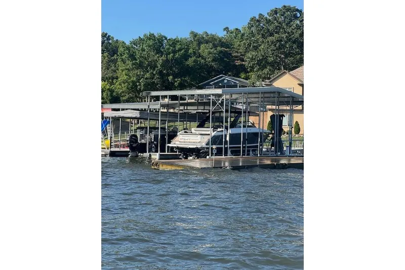 Slide: The Image of 2025 Cobalt R35 boat docked on a sunny lake with trees in the background. - 15