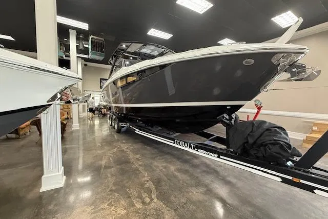 Slide: The Image of 2025 Cobalt R35 boat displayed indoors on a trailer. - 17