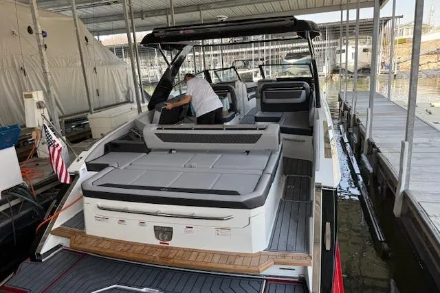 Slide: The Image of 2025 Cobalt R35 boat docked, featuring spacious seating and modern design. - 2