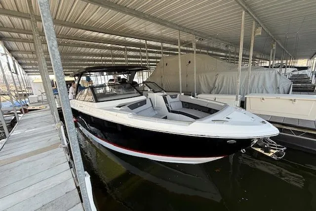 Slide: The Image of 2025 Cobalt R35 boat docked in a covered marina. - 3
