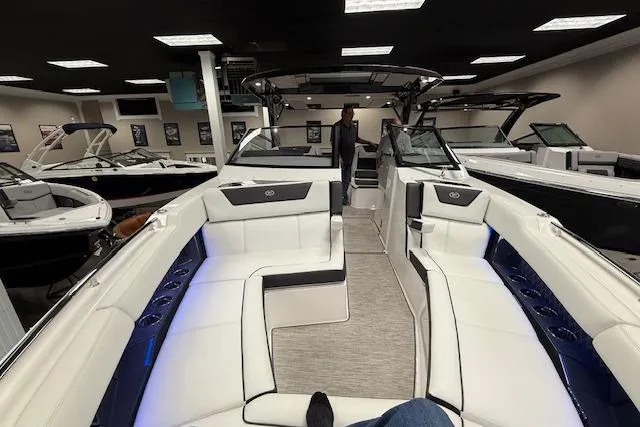 Slide: The Image of 2025 Cobalt R35 luxury boat interior with white seating and modern design in showroom. - 8