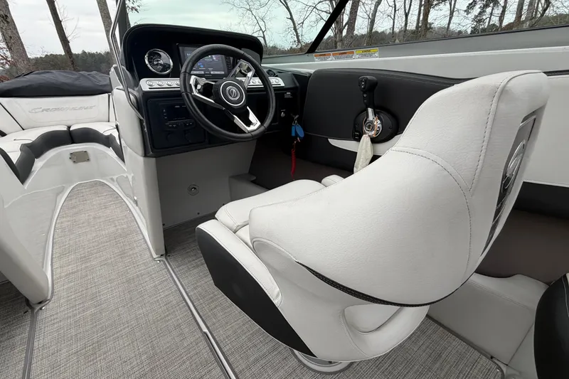 Slide: The Image of 2022 Crownline 240 SS boat interior with steering wheel and captain's seat. - 10