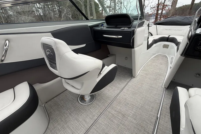 Slide: The Image of 2022 Crownline 240 SS boat interior with modern seating and sleek dashboard design. - 11