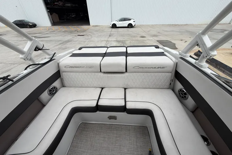 Slide: The Image of 2022 Crownline 240 SS boat interior with cushioned seating and speakers. - 4