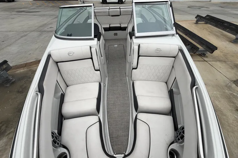 Slide: The Image of 2022 Crownline 240 SS boat interior with white seating and open windshield. - 6