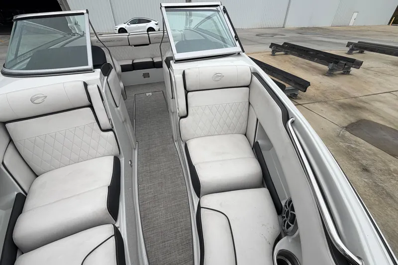 Slide: The Image of 2022 Crownline 240 SS boat interior with white seating and modern design. - 8