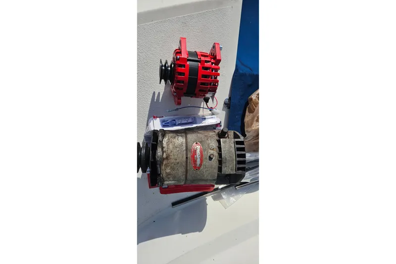 Slide: The Image of Engine room of a 1976 Hatteras 48 Long Range Cruiser with red diesel engine. - 24