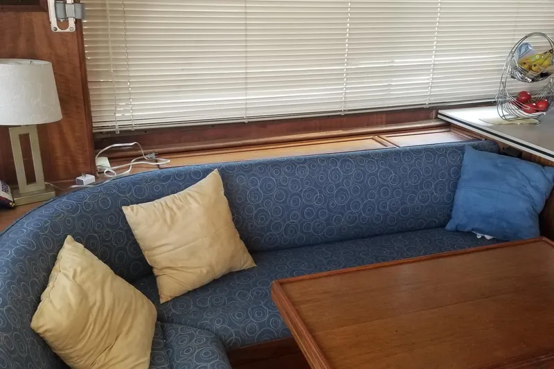 Slide: The Image of 1976 Hatteras 48 Long Range Cruiser with solar panels docked by the water. - 39