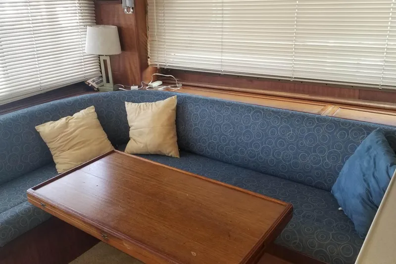 Slide: The Image of 1976 Hatteras 48 Long Range Cruiser with wooden steps and blue canvas cover. - 40