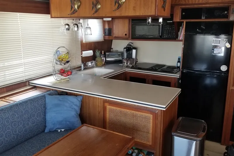 Slide: The Image of 1976 Hatteras 48 Long Range Cruiser kitchen with wood cabinetry and modern appliances. - 43