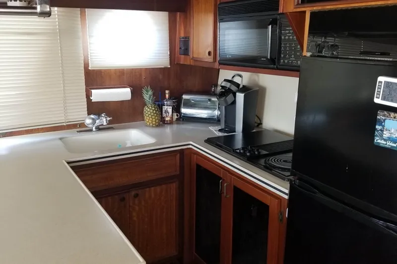 Slide: The Image of Interior of 1976 Hatteras 48 Long Range Cruiser with blue seating and wooden accents. - 44