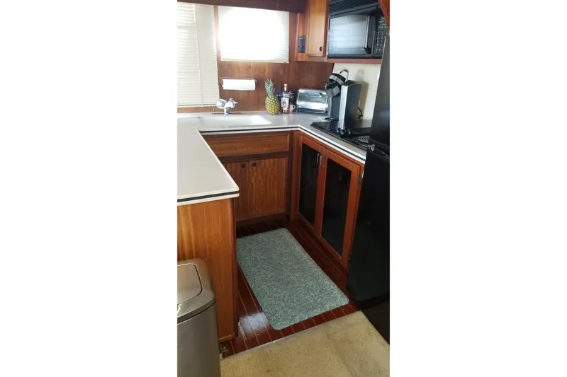 Slide: The Image of Interior of 1976 Hatteras 48 Long Range Cruiser with blue sofa and wooden accents. - 47