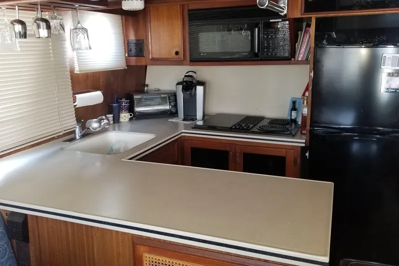 Slide: The Image of Interior of 1976 Hatteras 48 Long Range Cruiser with bookshelves and wooden cabinetry. - 48