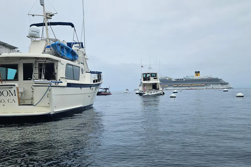 Slide: The Image of 1976 Hatteras 48 Long Range Cruiser yacht in marina, clear blue sky. - 5