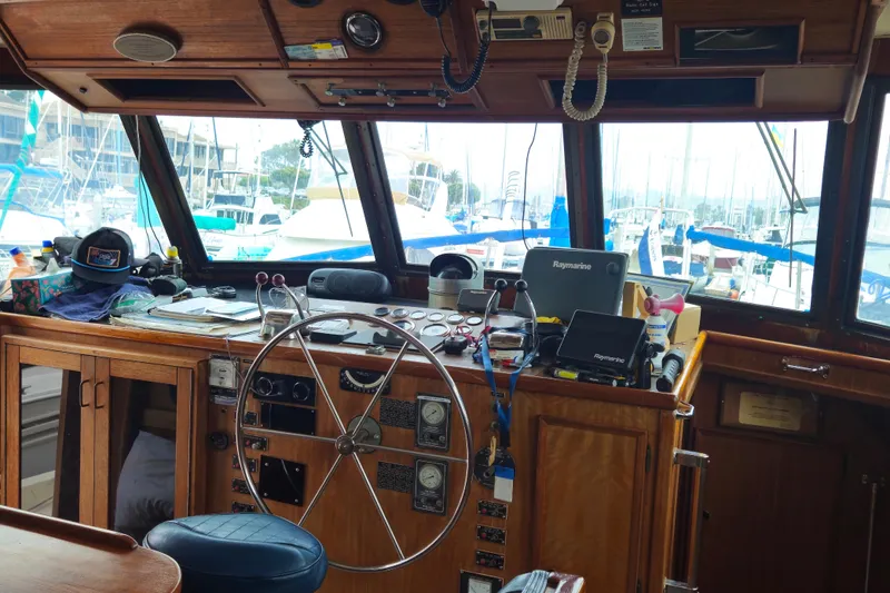 Slide: The Image of Bathroom interior of 1976 Hatteras 48 Long Range Cruiser with sink, toilet, and towels. - 53