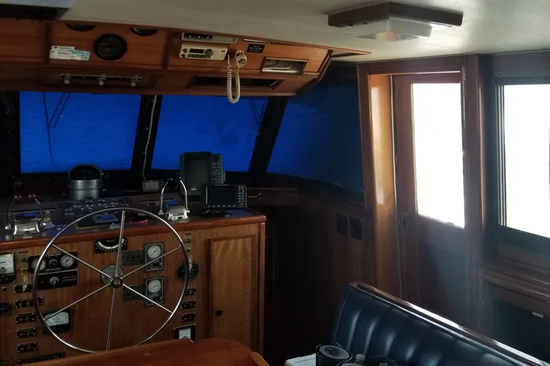 Slide: The Image of 1976 Hatteras 48 Long Range Cruiser cabin with bed, portholes, and TV. - 55