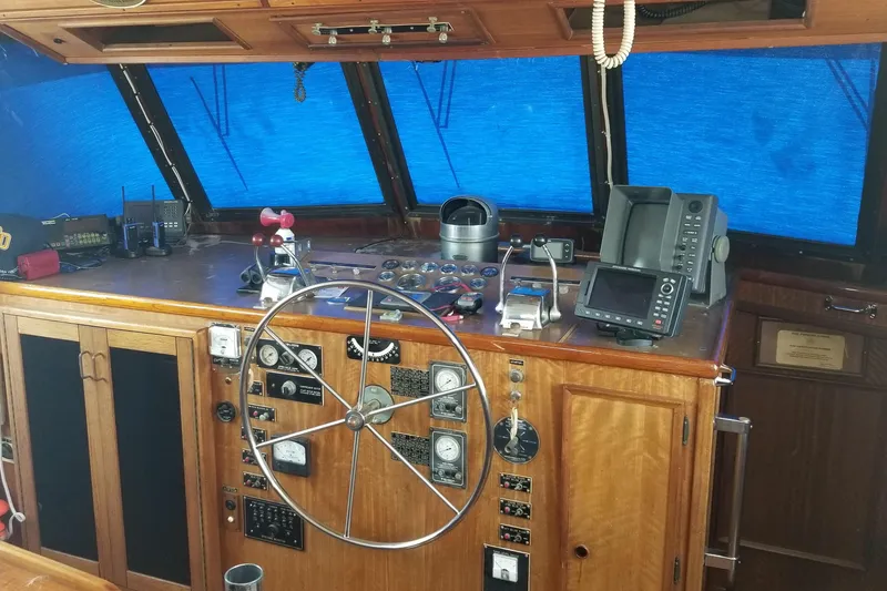 Slide: The Image of Bathroom interior of 1976 Hatteras 48 Long Range Cruiser with granite countertop and wooden accents. - 57