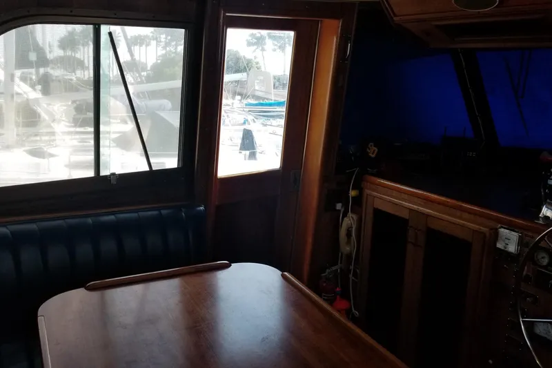 Slide: The Image of Interior staircase of 1976 Hatteras 48 Long Range Cruiser, featuring wooden paneling and carpeted steps. - 61