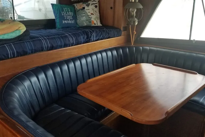 Slide: The Image of 1976 Hatteras 48 Long Range Cruiser helm with wooden dashboard and navigation equipment. - 63