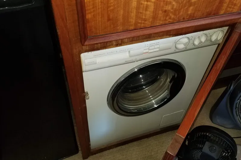 Slide: The Image of Engine room of 1976 Hatteras 48 Long Range Cruiser showing mechanical components and connections. - 72