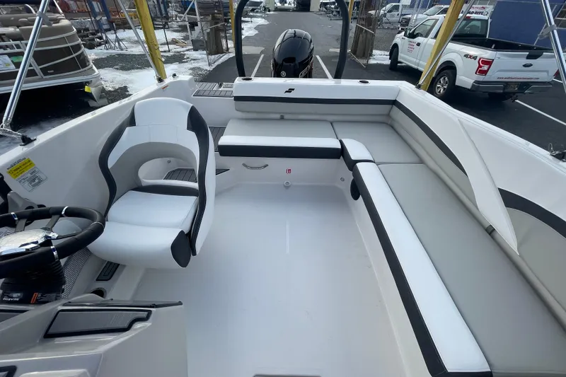 Slide: The Image of 2026 Starcraft SVX 191 OB boat interior with white seating and steering wheel. - 10