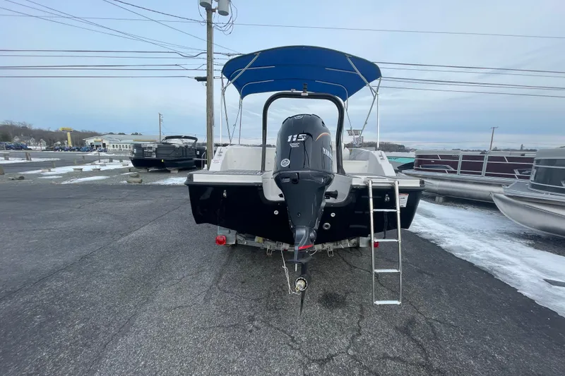 Slide: The Image of 2026 Starcraft SVX 191 OB boat with Yamaha 115 outboard motor and ladder, parked on pavement. - 11