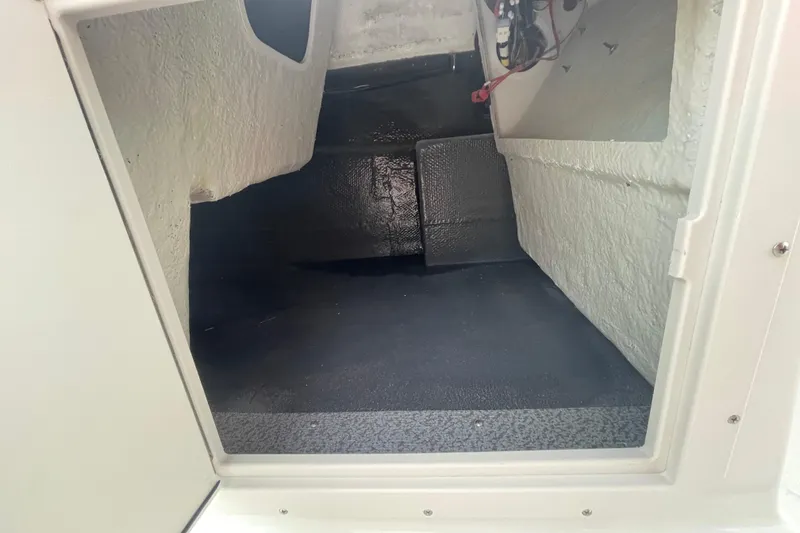 Slide: The Image of Interior storage compartment of 2026 Starcraft SVX 191 OB boat, featuring textured flooring. - 8