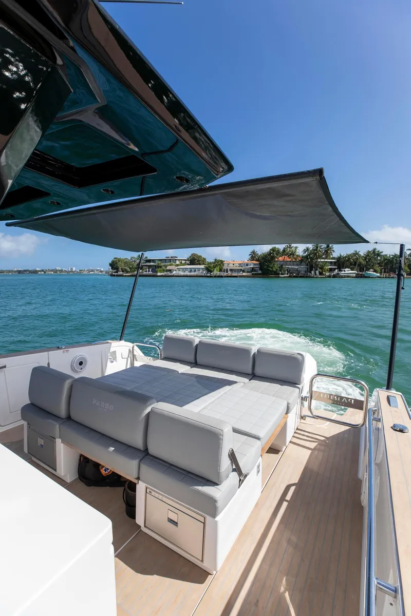 Slide: The Image of 2022 Pardo Yachts 38 cruising on blue water, featuring spacious deck and sunshade. - 10