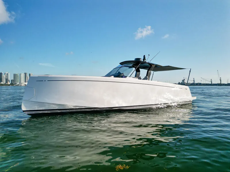 Slide: The Image of 2022 Pardo Yachts 38 cruising on calm waters under a clear blue sky. - 13