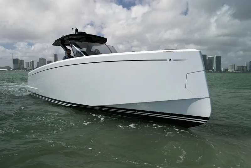 Slide: The Image of 2022 Pardo Yachts 38 cruising on water with city skyline in background. - 17