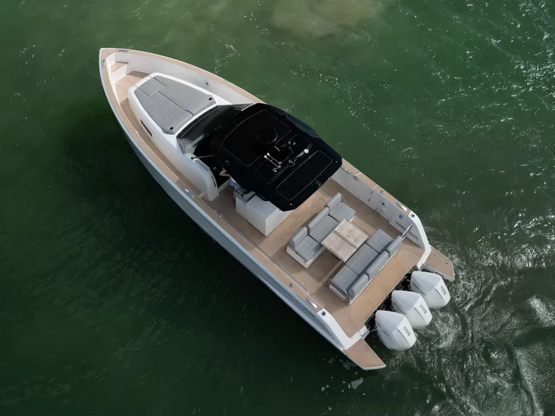 Slide: The Image of 2022 Pardo Yachts 38 on water, aerial view, showcasing sleek design and triple outboard engines. - 25