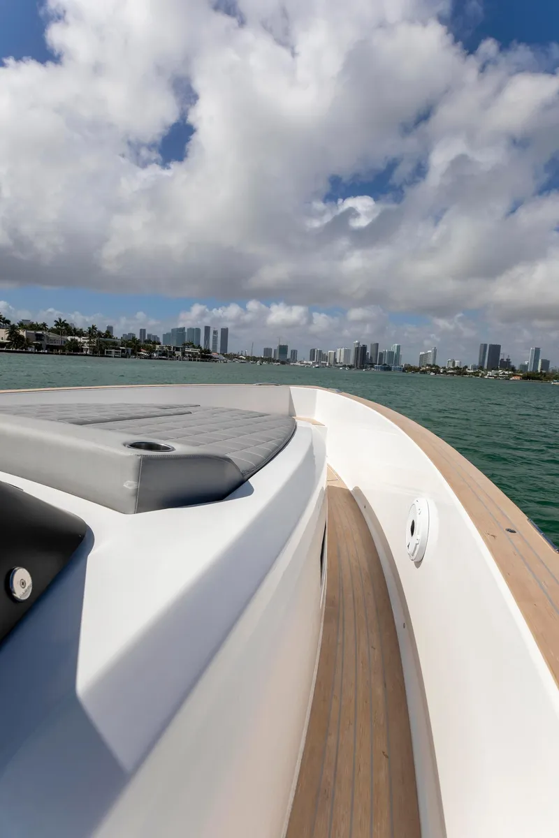 Slide: The Image of 2022 Pardo Yachts 38 cruising on water with city skyline in background. - 43