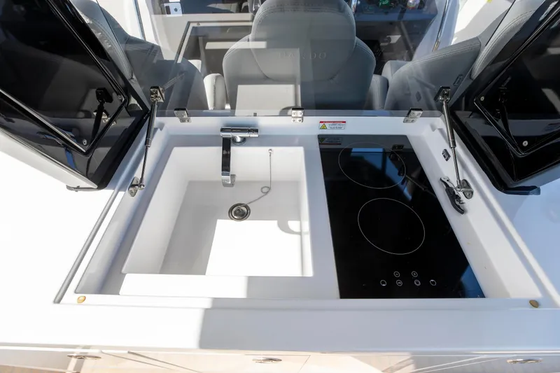 Slide: The Image of Modern kitchen area on 2022 Pardo Yachts 38, featuring a sink and electric cooktop. - 49